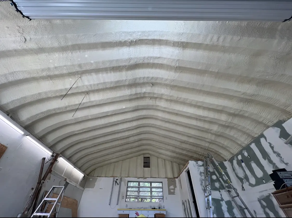 Spray polyurethane foam applied to the underside of a metal roof deck in Ipswich